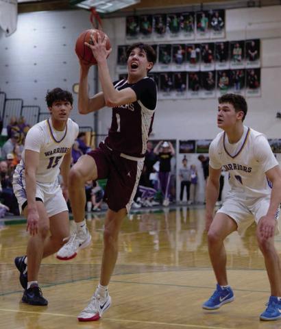 Left, Timber Lake forward Jackson Bigger (1) splits a pair of Castlewood defenders Leonard Wernke (15) and Kamden Keszler (0) on a drive to the hoop during the Panthers matchup with the Warriors in the SoDak 16 last Tuesday. Topic Photo/Marie Du Preez