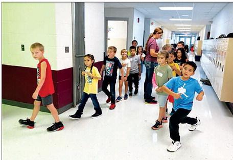 Second graders line up with the help of teacher Shanna Gebhardt on the first day of school at Timber Lake Elementary. Enrollment in the elementary school was at 196 the first week, up 30 from last year.