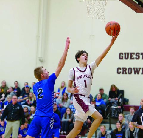 Timber Lake forward Jackson Bigger drives past Lemmon’s Drew Hetzel for a layup during the Panthers’ win over the Cowboys in the boys basketball season opener last Friday, Dec. 19. Bigger finished the contest with 13 points. Topic Photo/Marie Du Preez