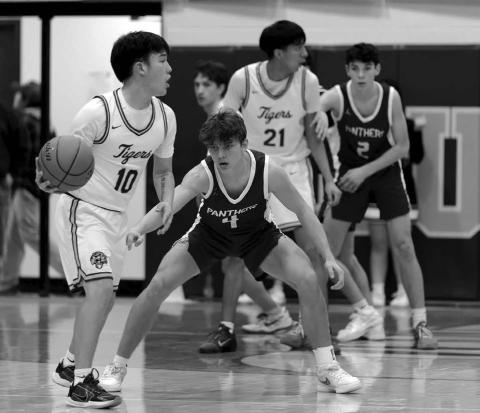 Dupree’s Tre White Wolf (10) surveys the floor while being defended by Timber Lake’s Broc Bauer. In the background, Ayden Uses Knife (21) is covered by Pete Maher (2). The Tigers knocked off the Panthers 63-60 last Tuesday, Feb. 3, for the second time in two weeks. Topic Photo/Marie DuPreez