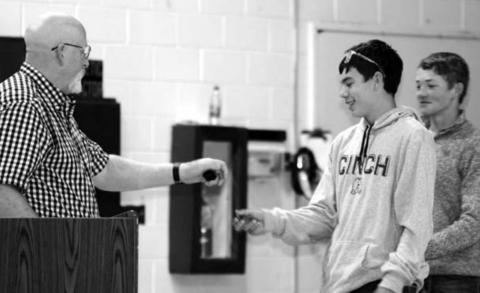 Mr. Shannon Hinrichs presenting best Geography student awards to (L-R) Haydon Starr and Treg Thorstenson.