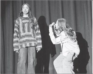 While Izzy (Zoey De La Rosa) shares various interesting facts about birds, Dove (Laynee Bakeberg) captures her emotions and expressions on camera. The two girls received superior acting awards at the regional one-act play competition.