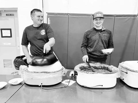 AT RIGHT: Brent Spafford and Riley Lindskov served up chili and chicken noodle soup at the Isabel Firemen’s Supper.