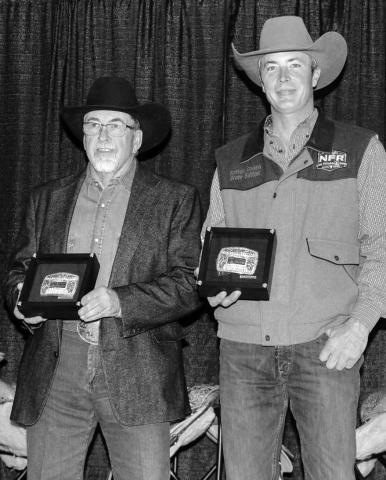 Dallas Schott (left) of McLaughlin and Brent Sutton of Sutton Rodeos, accept the buckles for the Bull of the Year and Bull of the Finals following this year’s PRCA Badlands Circuit Finals last month. Schott in the Dark - a son of the famed bull Bushwhacker - was crowned Bull of the Year.