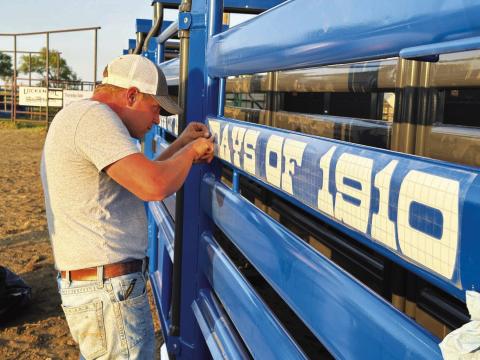 Mark Leibel, pictured, and other members of the Timber Lake Rodeo Association board of directors placed decals and sponsor panels on the seven new bucking chutes at the rodeo grounds in preparation for the Days of 1910 Rodeo this weekend. The SDRA/NRCA rodeo performances are set Saturday and Sunday nights at 6 p.m. and Sunday slack is at 8 a.m. Photo by Kathy Nelson