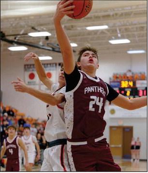 Left, Timber Lake’s Kanton Hunt (24) battles an unidentified defender for a rebound duing the Panthers ‘matchup with Mobridge-Pollockon Dec.16. Topic Photo/Marie DuPreez