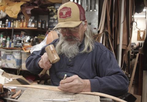 John Bachman, owner of the Eagle Butte Saddle Shop, has spent the better portion of his life working with leather. Photo by Jon Flatland