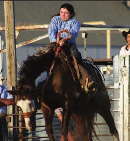 Photo by Jon Flatland Carl Petersen of Eagle Butte holds tight out of the gate while competing in the ranch bronc ride Saturday in McLaughlin.
