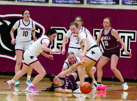Timber Lake and Newell players scramble for possession of a loose ball during Timber Lake Lady Panther action vs the Newell Irrigators last Friday, Feb. 13. The Lady Panthers pulled out an exciting 41-48 win over the Irrigators. The Timber Lake girls are used to exciting finishes as nearly half of their games this season have been decided one way or the other by seven points or less. Topic Photo/Marie DuPreez