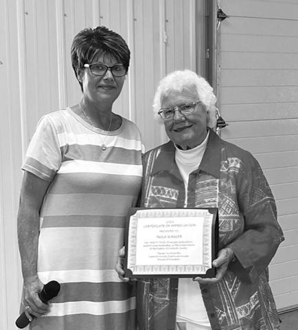 Sunday July 9, 2023 was celebrated as Twila Schuler Day in Dupree and Ziebach County. ABOVE, Darla Vrooman (LEFT) presents Twila with a plaque honoring her for 20 years of service and leadership in preserving Ziebach County history.