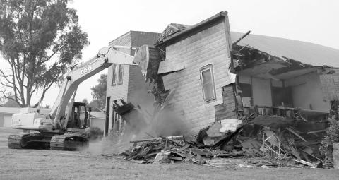 Trail City Take Down ... Part of Trail City’s history was turned to dust last Wednesday, Sept. 11, when the former Post Office and pool hall were leveled. Contracted to do the tear down was Jim and Bucky Bartlett and Beamon Kraft from Bartlett Ag Supply. Photo by Jon Flatland
