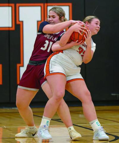 Kate Biegler (31) of Timber Lake wrestles for control of a rebound with Faith’s Shaie Veit in Faith last week. The Lady Panthers claimed their first win of the season with a thrilling 64-63 overtime victory. Biegler scored 12 points in the effort. Topic Photo by Marie DuPreez