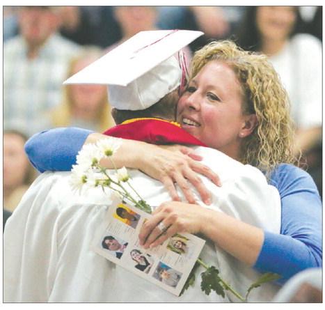Tennile Lindskov smiles as she hugs her son, A.J., after he presented her with flowers during the Timber Lake High School Class of 2023 graduation program on Sunday, May 7. A.J. was later presented his diploma by his father, Bryce, who serves as vicepresident of the Timber Lake School Board. Photo by Jon Flatland