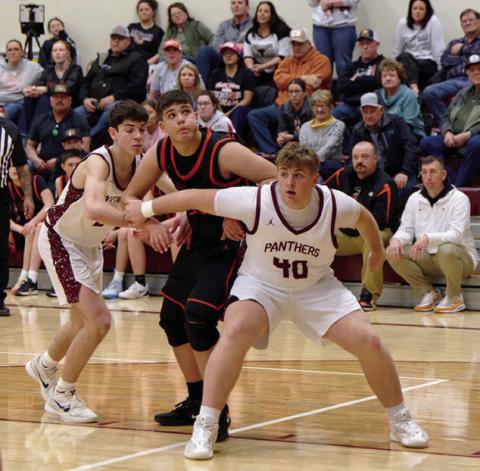 Left, Timber Lake’s Mason Bickel (40) boxes out a Faith defender as they eye a shot going up. Moving in for a potential rebound is Timber Lake’s Petet Maher. Topic Photo/Marie DuPreez