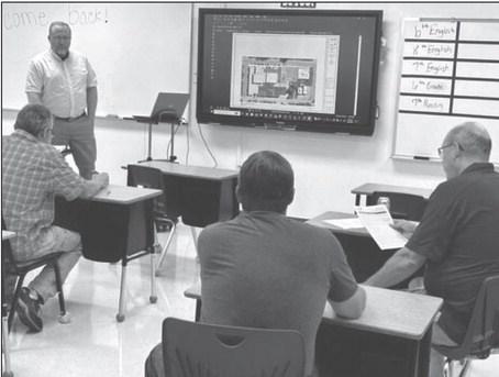 John Paul, standing, of Johnson Controls, fields questions from Timber Lake School officials last Wednesday, Aug. 23, while discussing a $1.8 million HVAC improvement project the board approved later in the evening. Photo by Jon Flatland