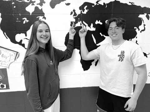Photo by Kathy Nelson Exchange students Carla Del Rio Larrea (LEFT) and Francesco Barbini point to their home countries of Spain (Carla) and Italy (Francesco) on the map at Timber Lake High School. Carla spent the school year with Bryce and Colette Schaffer, and Francesco was hosted by Leah Peterson and her son Dan. The map was created by last year’s exchange students.