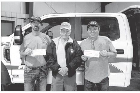 Moreau-Grand board chairman Larry Hieb (MIDDLE) presents a check for $1000 to Jeremy Bollinger (LEFT) and Grady Kraft (RIGHT) of the Timber Lake Volunteer Fire Department.