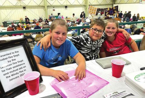 Titcket takers and honorary/future firemen (L-R) Cody Russell, Gabe Bridges and Trent Russell greeted attendees of the Isabel Volunteer Fire Department’s fundraiser Oct. 23. Photo by Kathy Nelson