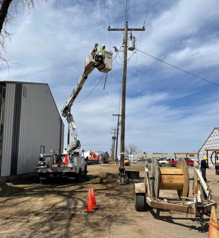 ABOVE: A Moreau-Grand crew gets ready to move a pole in the alley of Block 17 behind the post office.
