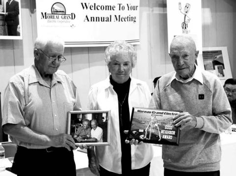 Moreau-Grand Electric board president Larry Hieb (EFT) presents the Good Neighbor Award to Keva and Andy Aberle of Timber Lake at the M-G annual meeting.