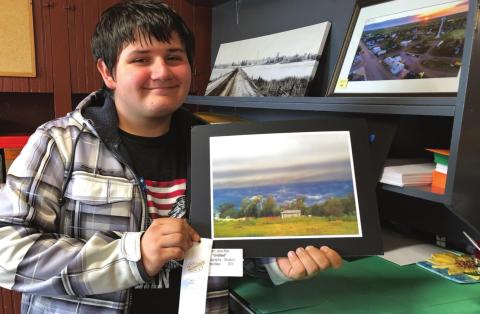 Jesse Ridl of Timber Lake with his photograph that won a ribbon at the Mobridge Art Show.