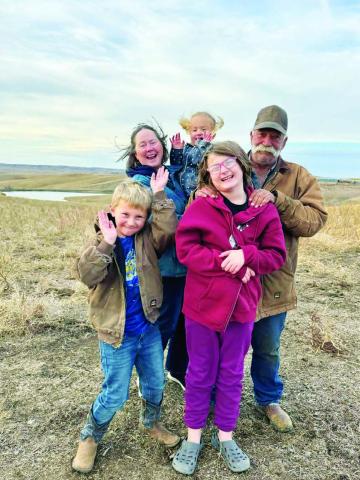 Arden and Lori Petersen with their on-ranch grandkids.