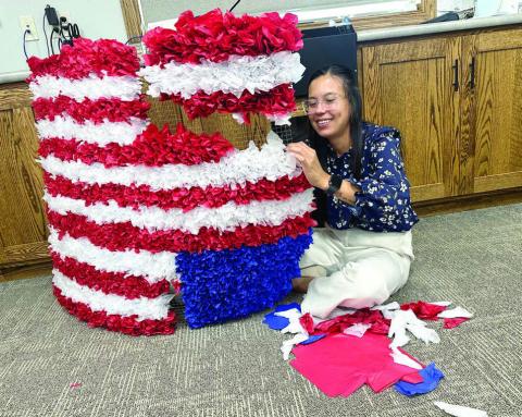 Sierra Eagleman stuffs tissue paper in a screen for Western Dakota Bank’s float which will appear in the Timber Lake and Isabel parades the next two Saturdays. See details about both celebrations inside this issue. Photo by Kathy Nelson