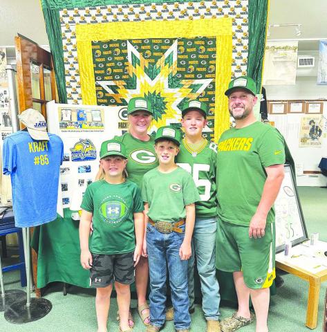 The Krueger family from Arbor Vitae, Wisconsin visited Timber Lake last week to get a look at Tucker Kraft’s hometown. They are friends of Cody and Tracy Maher and Terry Renderneck and were on their way to Yellowstone. They came dressed in Packers attire but stopped at Dakota Image to pick up some more. They saw the Tucker Kraft exhibit at the Museum (above) and had lunch at The Corner Bar &amp; Grill.