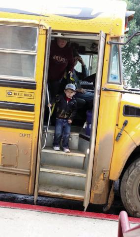 Pre-Kindergarten student Kazmer Lamb, son of Kritter and Kamy Lamb, wasn’t sure what to make of his bus ride to the first day of school on Tuesday or why there was a guy with a camera waiting for him when the bus doors opened but he slowly worked up the confidence to step off the bus and enter the school. Photo by Jon Flatland