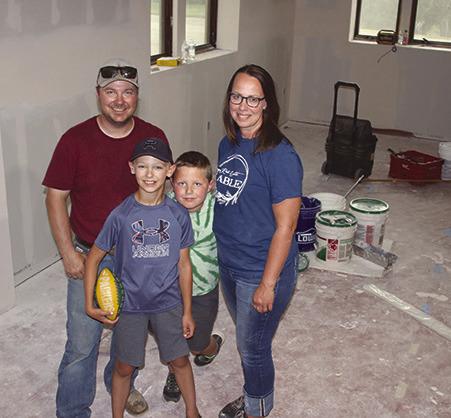 Chance and Merretta Anderson, shown with sons Gus and Hank, have purchased the former Masonic Lodge in Isabel and are currently remodeling the building to become the new home of Red Earth Table, an expansion of their already successful home-based bakery. They plan to open the bakery and breakfast diner this fall. Photo by Jon Flatland