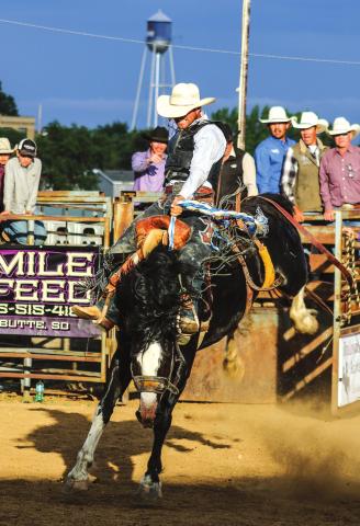 Wyatt Schuelke, Faith, rides one down at the match bronc ride in Dupree last Friday. Photo by Jon Flatland