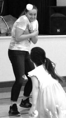 RIGHT: NHS member Erin Lemke prepares herself, acting like it’s going to be bad, as a PreK student throws a soft indoor “snowball” at her.