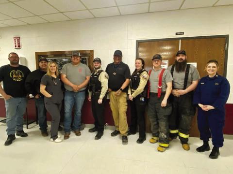Community heroes honored at Timber Lake Elementary on March 21 included these firefighters, EMTs, law enforcement officers, county road crew, and nurses. L-R: Justin Webb, Will Wiedmer, Rachael Goldade, Keith Jewett, Kyle Nilson, Ash Arpan, Trista Bulit, Brent Gill, Shad Bollinger, and Veronica Handeland.