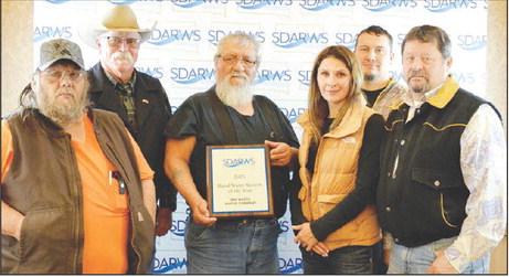 Accepting the Rural Water System of the Year Award were (l-r) Eddie Longbrake, employee; Bob Booth, board VP; Rolland Collins, board president; Lacy Maher, employee; Danny Marshall, employee; and Leo “Earp” Fischer, executive director. Not pictured are board members Oren Lesmeister, Rhae Washburn, Dave Hump and Lynn Williams.