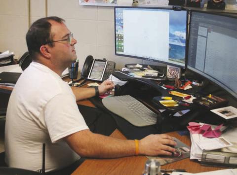 Timber Lake School IT Director Joel Schweitzer looks over plans for the $120,000 replacement of internet components aimed at keeping the district up-to-speed on the information superhighway. Photo by Jon Flatland