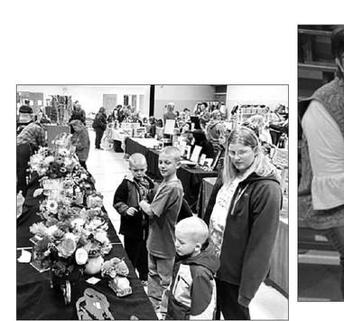 Twenty-seven vendors, some with two tables of wares, drew browsers at shoppers at the annual Fall Craft Fair at Timber Lake on November 5. Here Megan Zeug and sons (L-R) Eli, Isaac and Andrew admire wooden flowers.