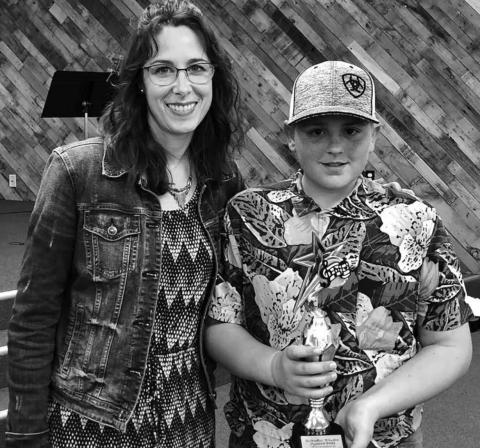 LEFT: Colette Schaffer presented Mason Bickel with the Studio Award. Mason composed and performed an original song, with lyrics.
