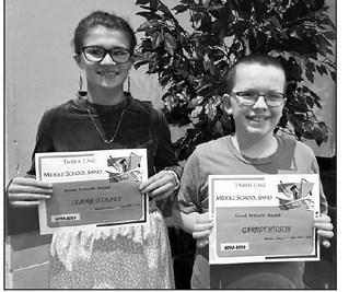 Claire O’Leary (left) and Garrett Nilson received the Good Attitude Award from music teacher Walker Rose.