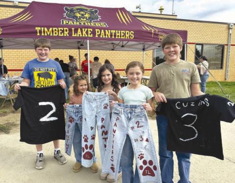 The Timber Lake Booster Club had a jeans and shirts painting booth at the Homecoming Kick-off on Sunday afternoon. Showing their handiwork are (l-r) Brody Kraft, Jensyn Booth, Blake Booth, Joey Kraft, and Monroe Kraft.