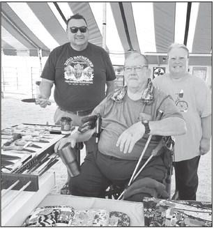 Art Rave of Isabel (left) inspected the knives and other creations that Mike and Dawn Stocklin of Faith showed at the Days of 1910 Vendor Fair.