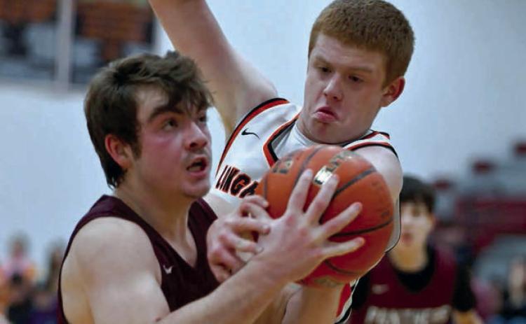 Timber Lake sophomore Treyden Beer (left) eyes the basket while being defended by Faith’s Tace Berglund on a drive into the lane during Little Moreau Conference basketball action last week. Photo by Marie DuPreez
