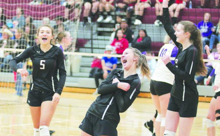 Timber Lake’s Shay Kraft, Carlie Lawrence and Sara Holzer celebrate the winning point in their match against Harding County after overcoming a nine-point deficit in the first round of the Little Moreau Conference Volleyball Tournament played Saturday, Sept. 24, in Faith. Photo by Jon Flatland