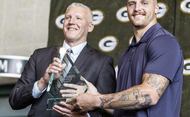 Green Bay Packers tight end Tucker Kraft, a native of Timber Lake, was presented the Packers 2025 Community Service Award last Friday, Aug. 22. Presenting the award was Ryan Krumrie, a partner at Hager, Dewick &amp; Zuengler, S.C. and Chairman of the Greater Green Bay Chamber of Commerce. Photo by Madison Morris courtesy of Green Bay Packers.