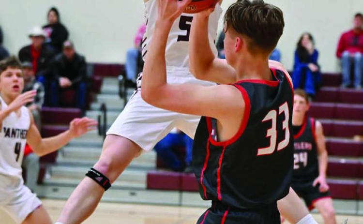 Timber Lake junior forward Holden Gill (5) leaps while attempting to block an outlet pass by Potter County’s Jonah Pribyl (33) last Friday, Feb. 28. The Panthers won a nail-biter and are playing in the Region 8B Tournament this week. Photo by Marie DuPreez