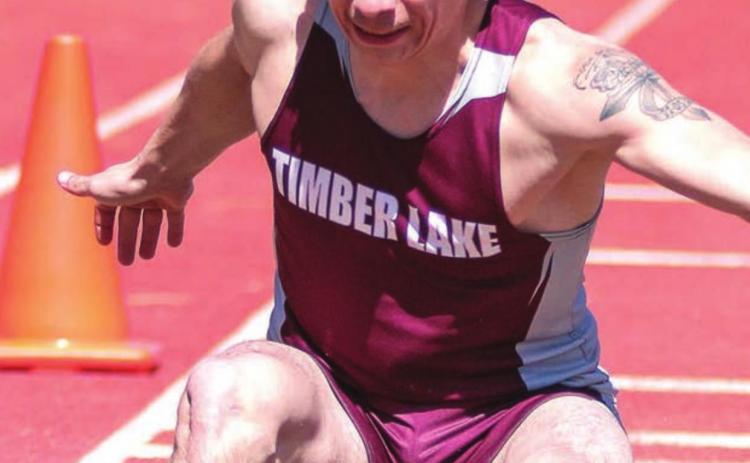 Timber Lake leaper Slater Ducheneaux touches down in the sand pit. File photos by Jon Flatland