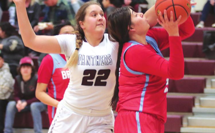 Timber Lake senior Tessa Goldade defends an attempt at the basket by Cheyenne-Eagle Butte’s Shawnee Lawrence during their Feb. 18 contest in Timber Lake. Photo by Jon Flatland