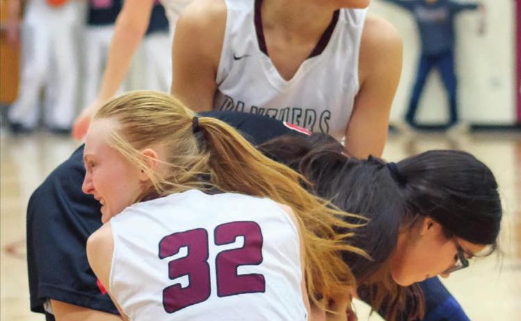 Timber Lake’s Jasmine Nash and Jordan Jones (32) tie up the ball with a Lyman player during their Dec. 28 varsity game in Timber Lake. Photos by Robert Slocum
