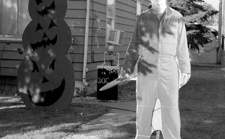 There’s not a crazy man with a knife loose in Timber Lake ... that’s just a cardboard cutout of Jason from the Halloween horror movie series hanging out in the front yard of Bruce Schweitzer along with some scary pumpkins, a toxic waste barrel and more. Photo by Jon Flatland