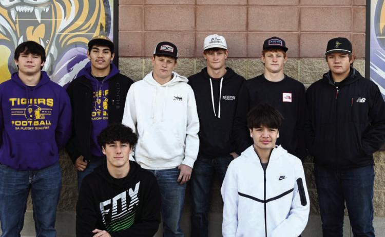 The 2025 Little Moreau Conference champion Dupree Tigers, above, had eight players selected to receive all-conference football honors. Pictured are front row (l-r) Traden Meeks and Ricco Swallow, both honorable mention selections, and in the back row (l-r) are all-conference honorees Michael Donovan, Braxton Schad, Tee Birkeland, Cruz Birkeland, Fletcher Birkeland and Tanner Thorstenson. Above right, seniors Tayshaun Cudmore and Spencer Olsen (l-r) were Class A Cross Country All-State selections for posting