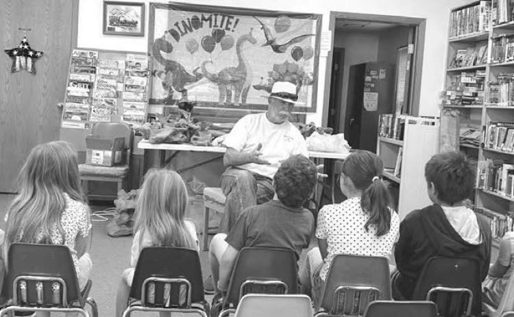 Greg Garon of Timber Lake talked about paleontology at the Dewey County Library’s Summer Reading Program on July 1. The theme of this year’s summer reading program is “Unearth a Story.” Programs continue on July 8, 15, 22 and 29. Attending last week were: Leon Shoots the Enemy, Rhett Aberle, Marie Bad Warrior, Eddie Vogel, Maren Maher, Rowan Maher, Remi Aberle, and Taylor Dupris. Photo by Ann Arnold